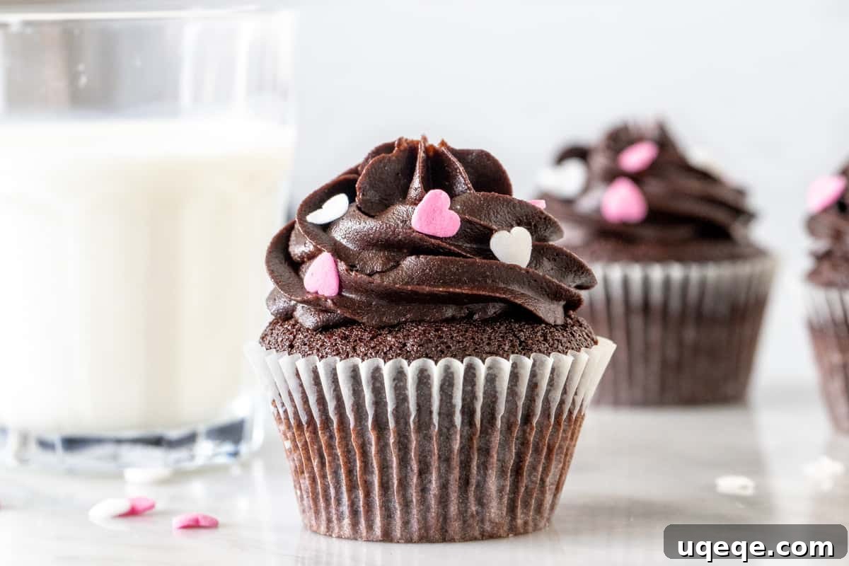 Mini Chocolate Delights 4 A trio of small-batch chocolate cupcakes adorned with generous swirls of chocolate frosting and colorful sprinkles, beautifully arranged for a festive touch.