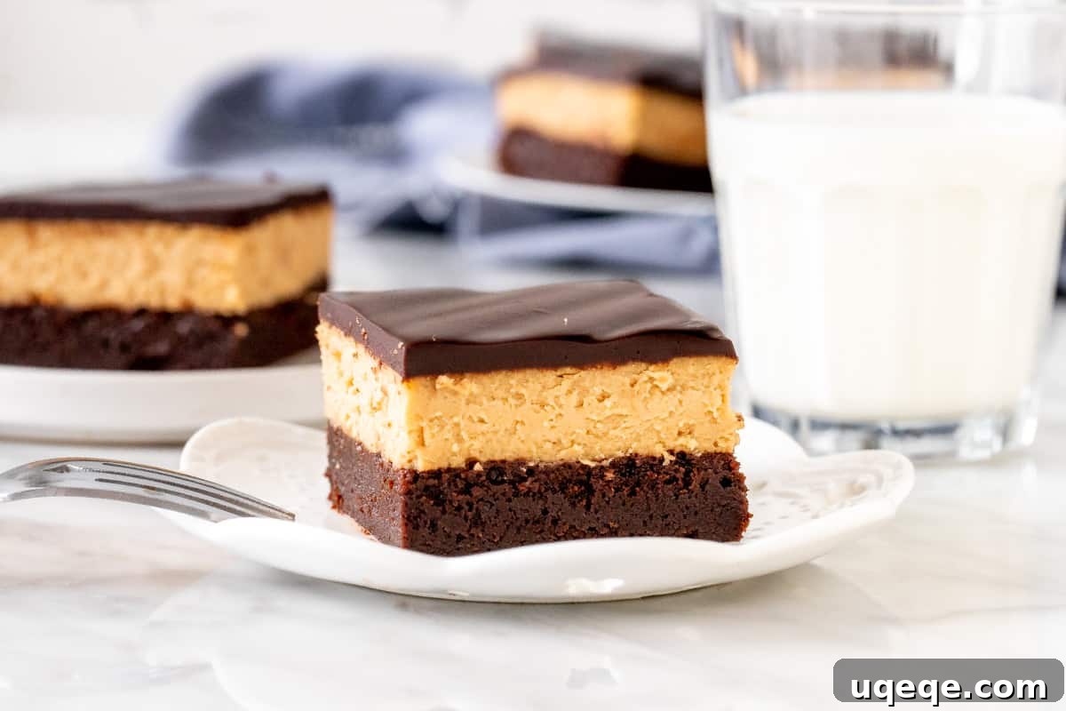 Ultimate Peanut Butter Cheesecake Brownies 3 Triple layer peanut butter brownie on a plate, showcasing the distinct layers.