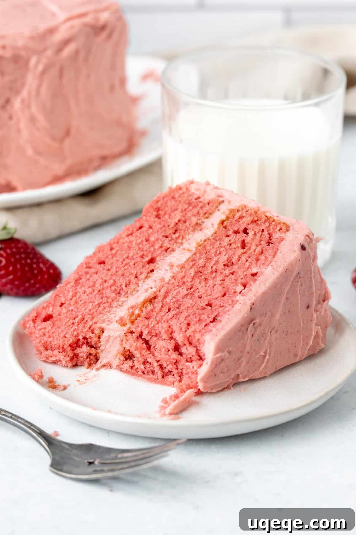 Sweet Strawberry Dream Cake 10 A beautifully frosted homemade strawberry layer cake, ready for serving, showcasing its vibrant pink color and enticing texture.