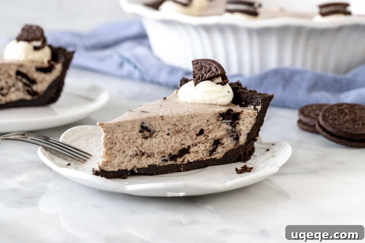 Ultimate Oreo Indulgence 7 A perfectly sliced piece of Oreo cream pie on a plate, showing the layers of crust and filling.