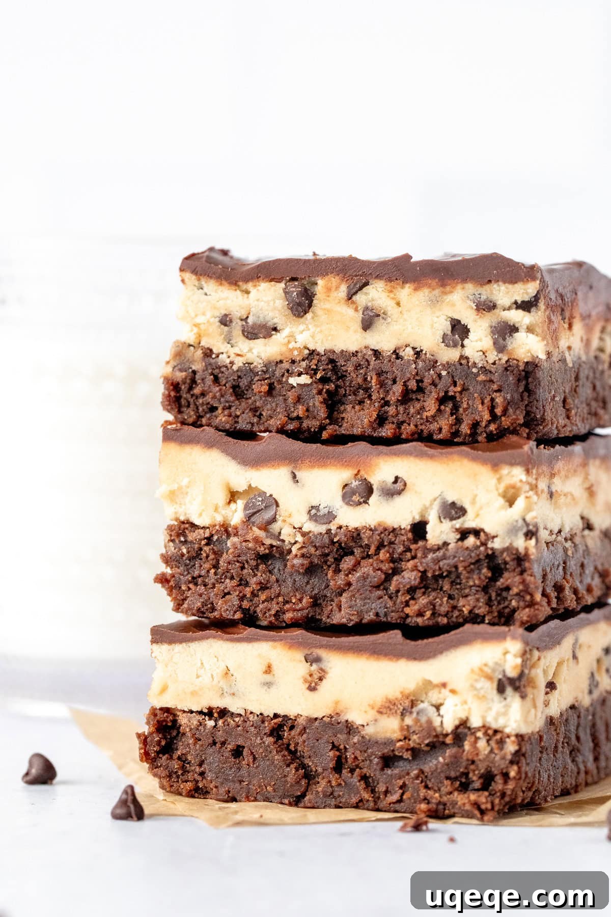 Ultimate Cookie Brownie Bars 2 Stack of three irresistible cookie dough brownies with fudgy layers, edible cookie dough, and a shiny chocolate topping.
