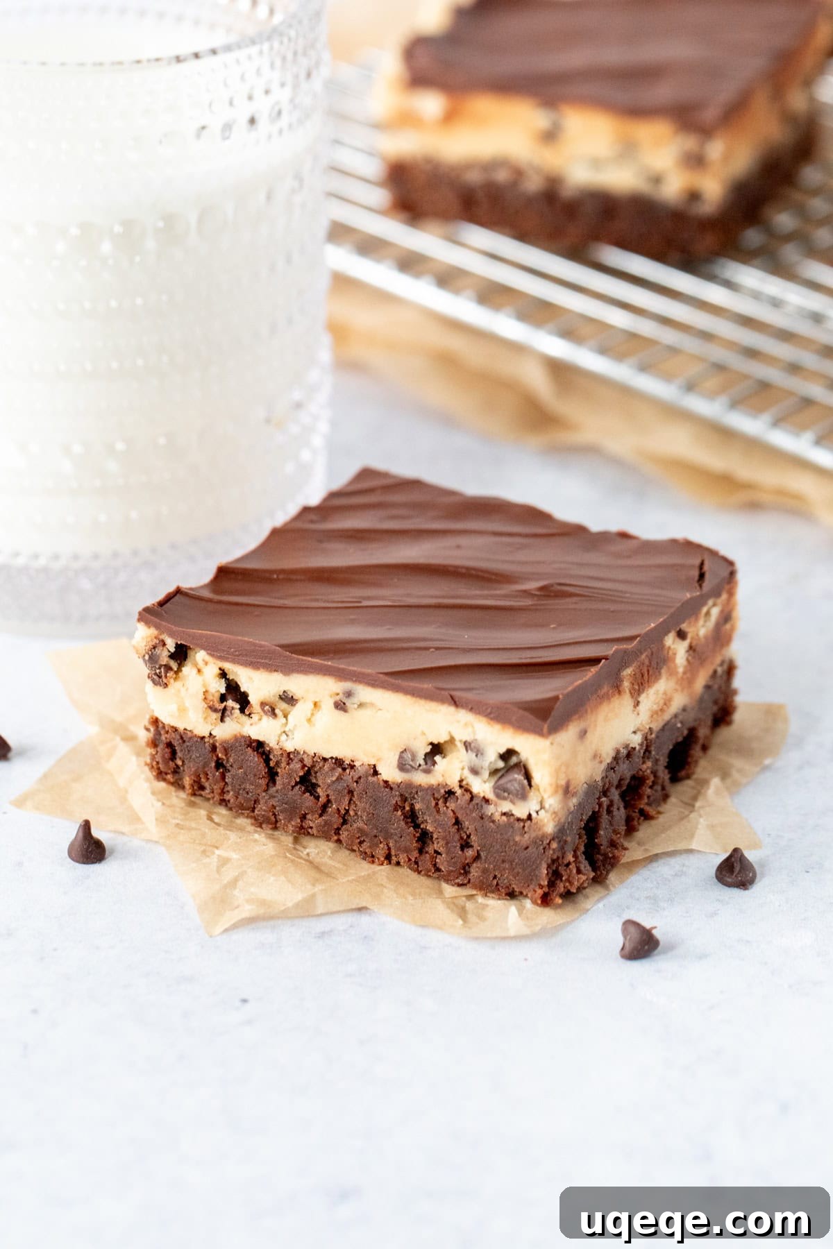 Ultimate Cookie Brownie Bars 12 A delicious cookie dough brownie resting beside a refreshing glass of milk, highlighting a perfect dessert pairing.