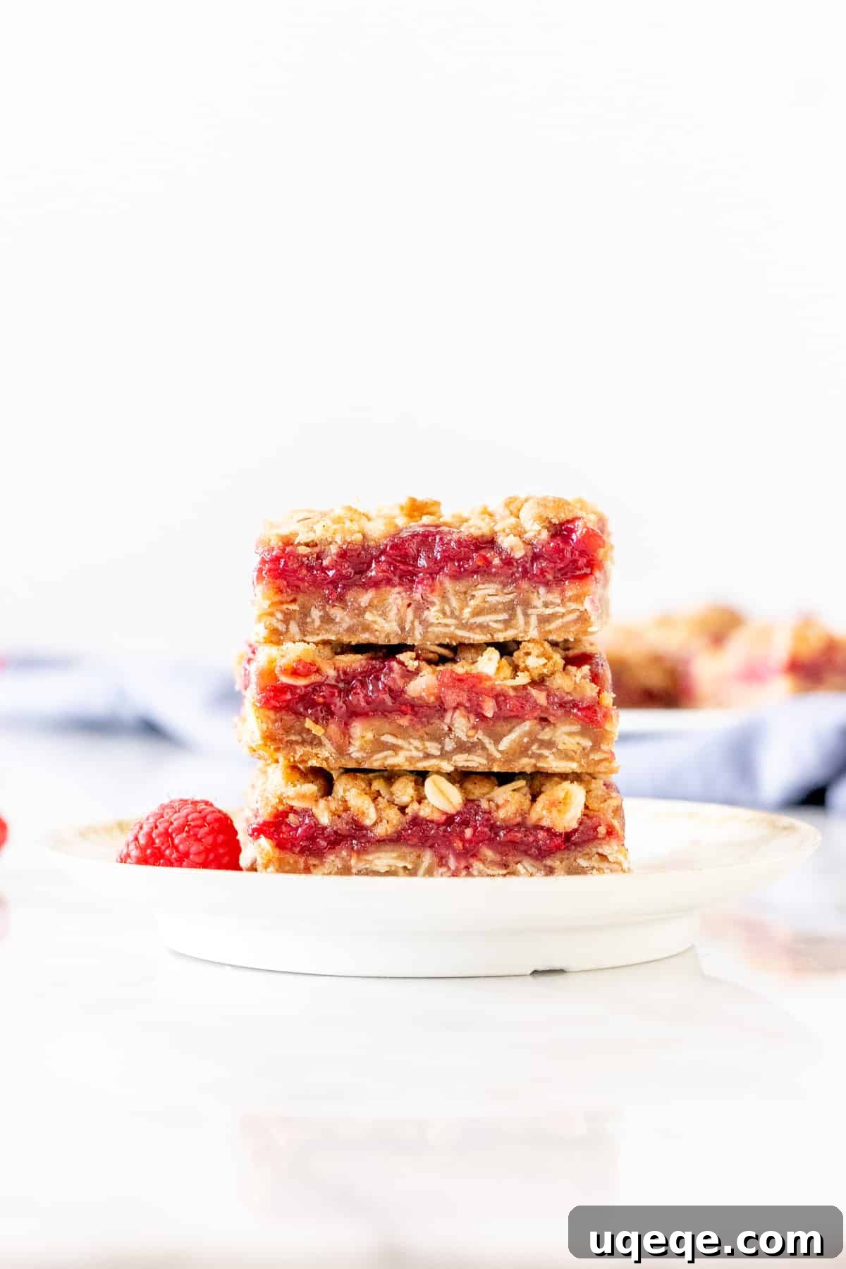 Homemade Raspberry Bars 2 Stack of 3 homemade raspberry crumble bars, showcasing the filling and crumb topping.