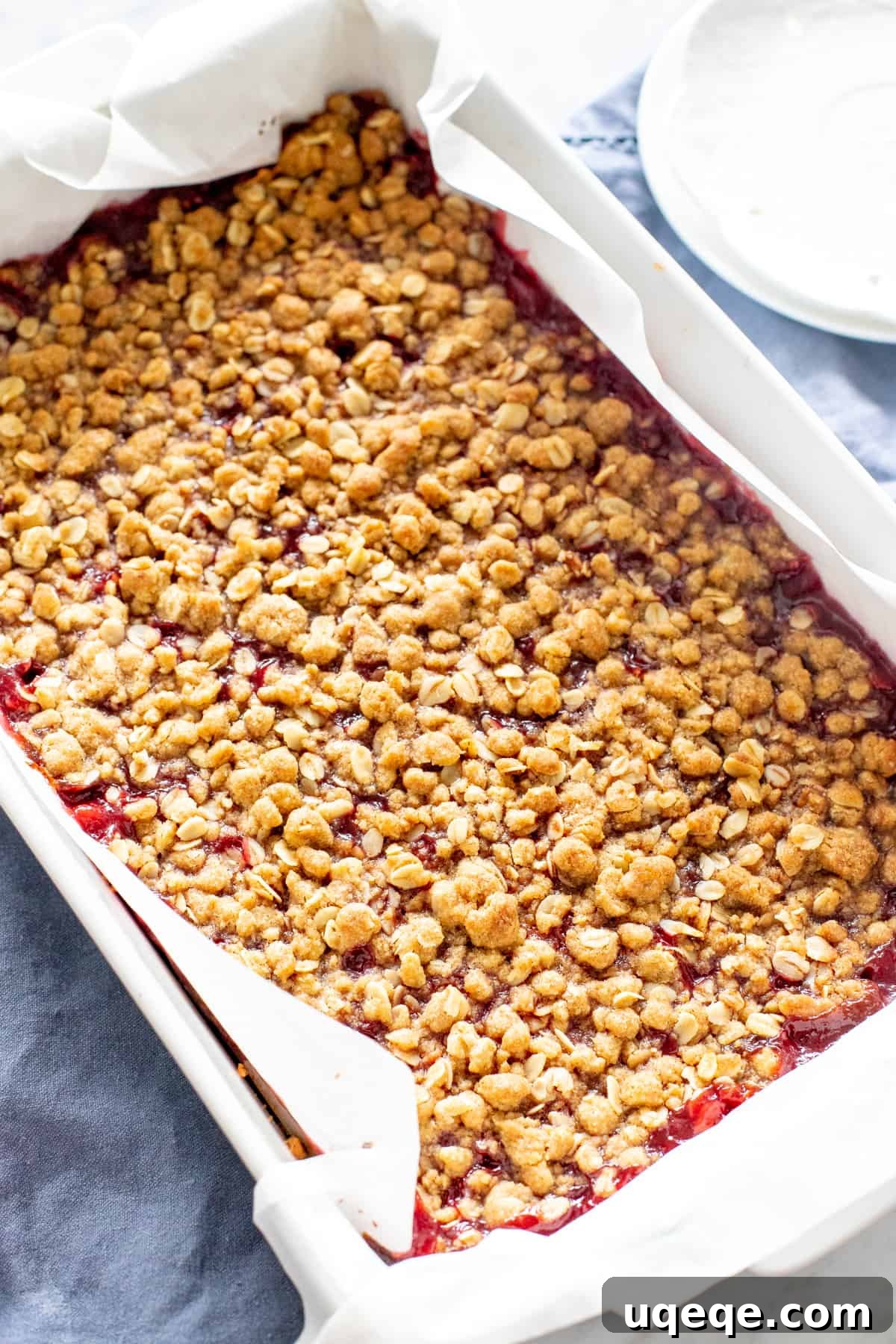 Homemade Raspberry Bars 5 A 9x13 inch baking pan filled with golden-brown raspberry bars, fresh out of the oven.
