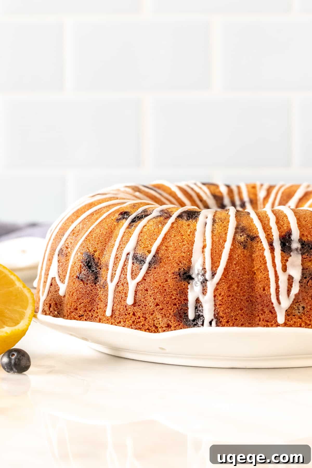 Sunshine Lemon Blueberry Bundt 2 Glazed lemon blueberry bundt cake on a plate