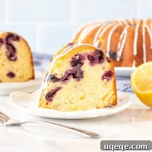 Slice of lemon blueberry bundt cake with fork