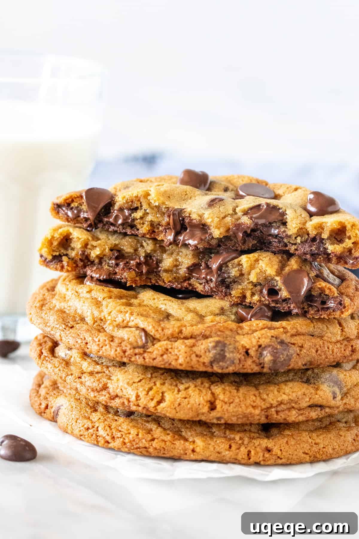 Signature Bakery Chocolate Chip Delights 2 Stack of bakery chocolate chip cookies with top cookie broken in half, revealing gooey chocolate chips and a soft center