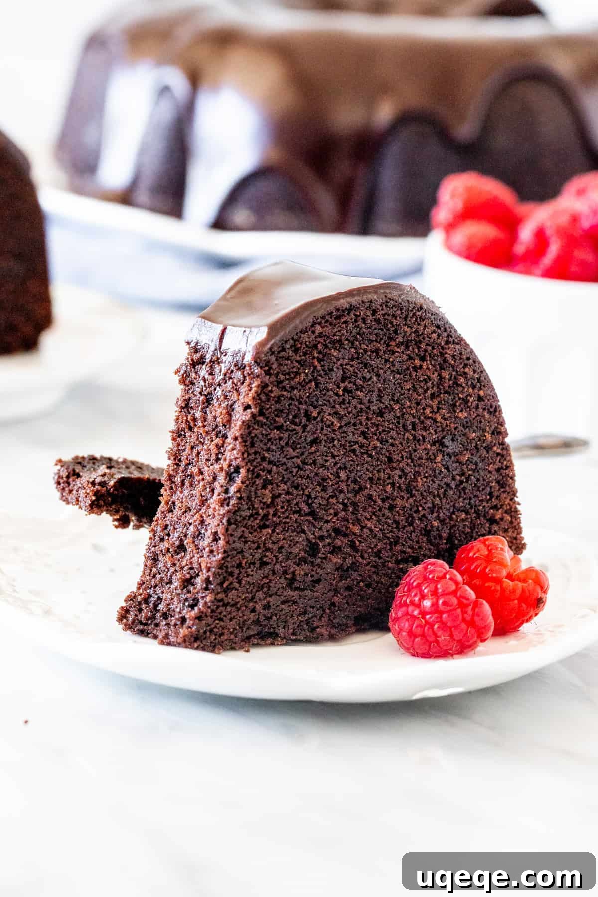 Decadent Chocolate Pound 2 Slice of chocolate pound cake with ganache drizzle and raspberries
