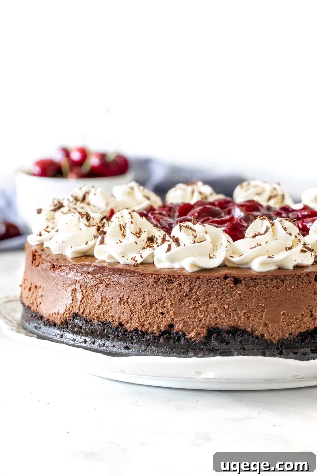 Midnight Cherry Cheesecake 2 Black Forest Cheesecake with whipped cream and cherries on top, ready to be served