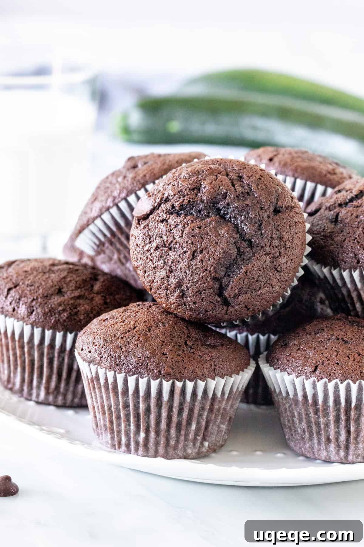 Moist Chocolate Zucchini Delights 2 A plate of freshly baked chocolate zucchini muffins, showcasing their moist texture and rich chocolate chips. The perfect treat for breakfast or a snack, using garden-fresh zucchini.
