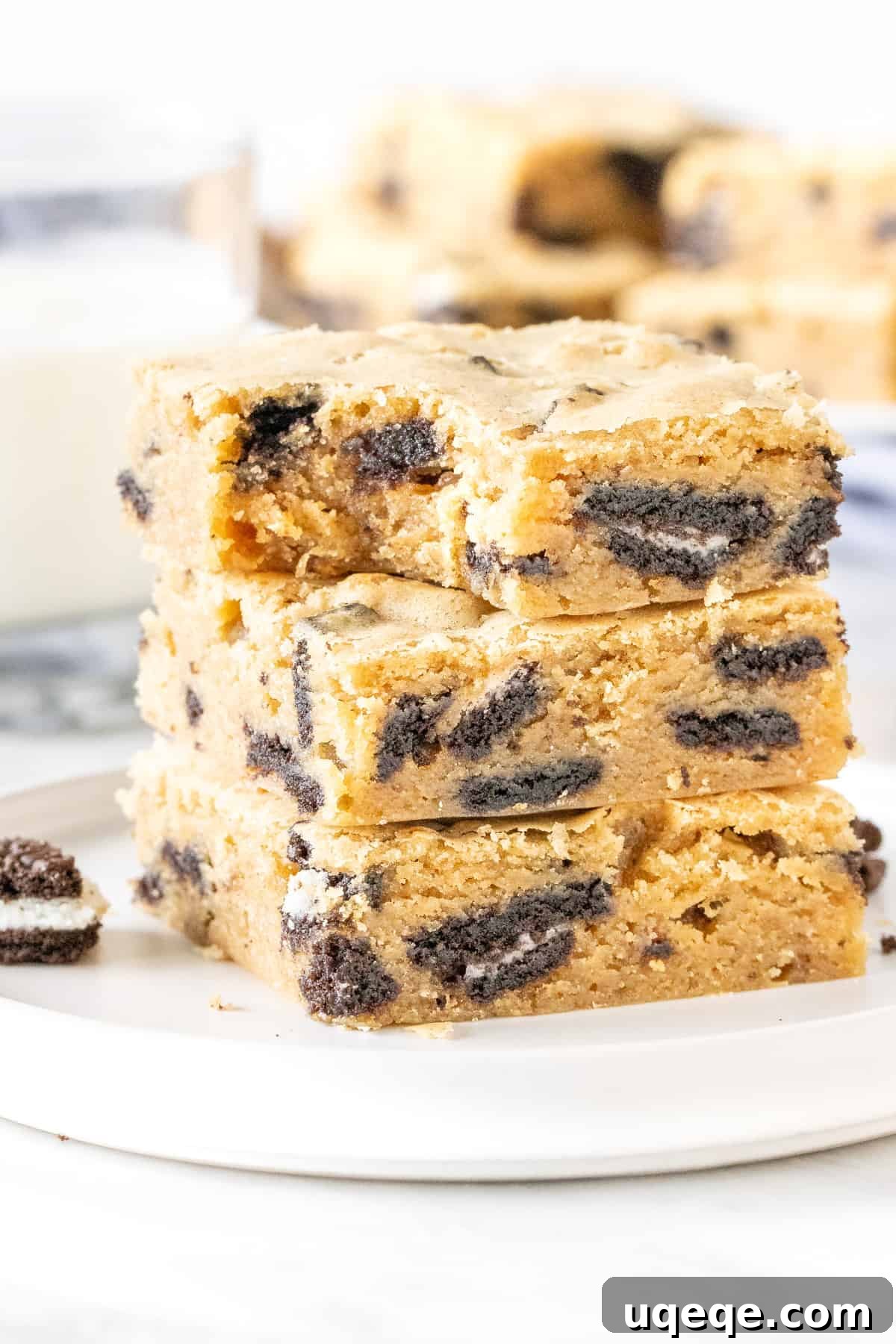 Cookies and Cream Dream Bars 5 Stack of Oreo blondies on a plate with a glass of milk
