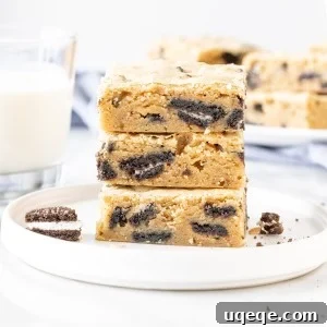 3 Oreo blondies stacked on a plate