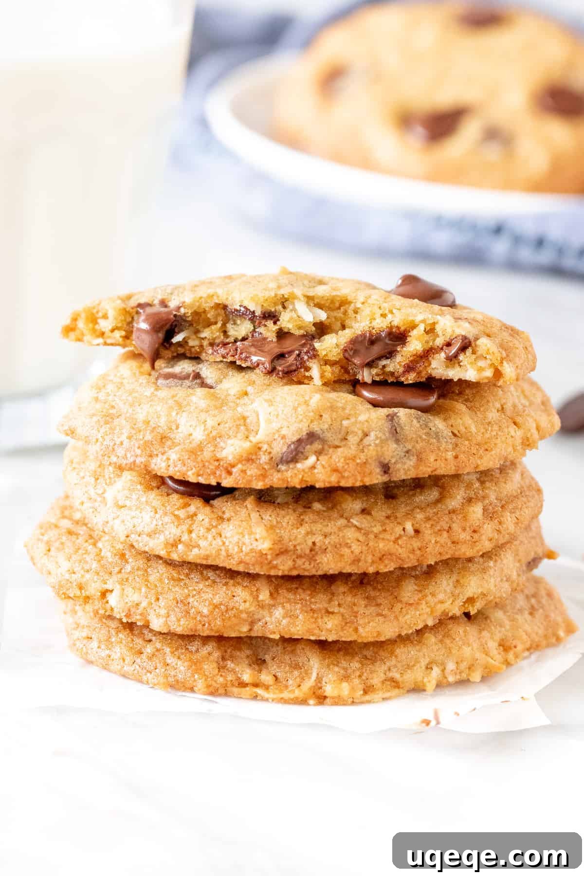 Irresistible Coconut Chocolate Chip Delights 4 Stack of freshly baked coconut chocolate chip cookies with a refreshing glass of milk, ready to enjoy