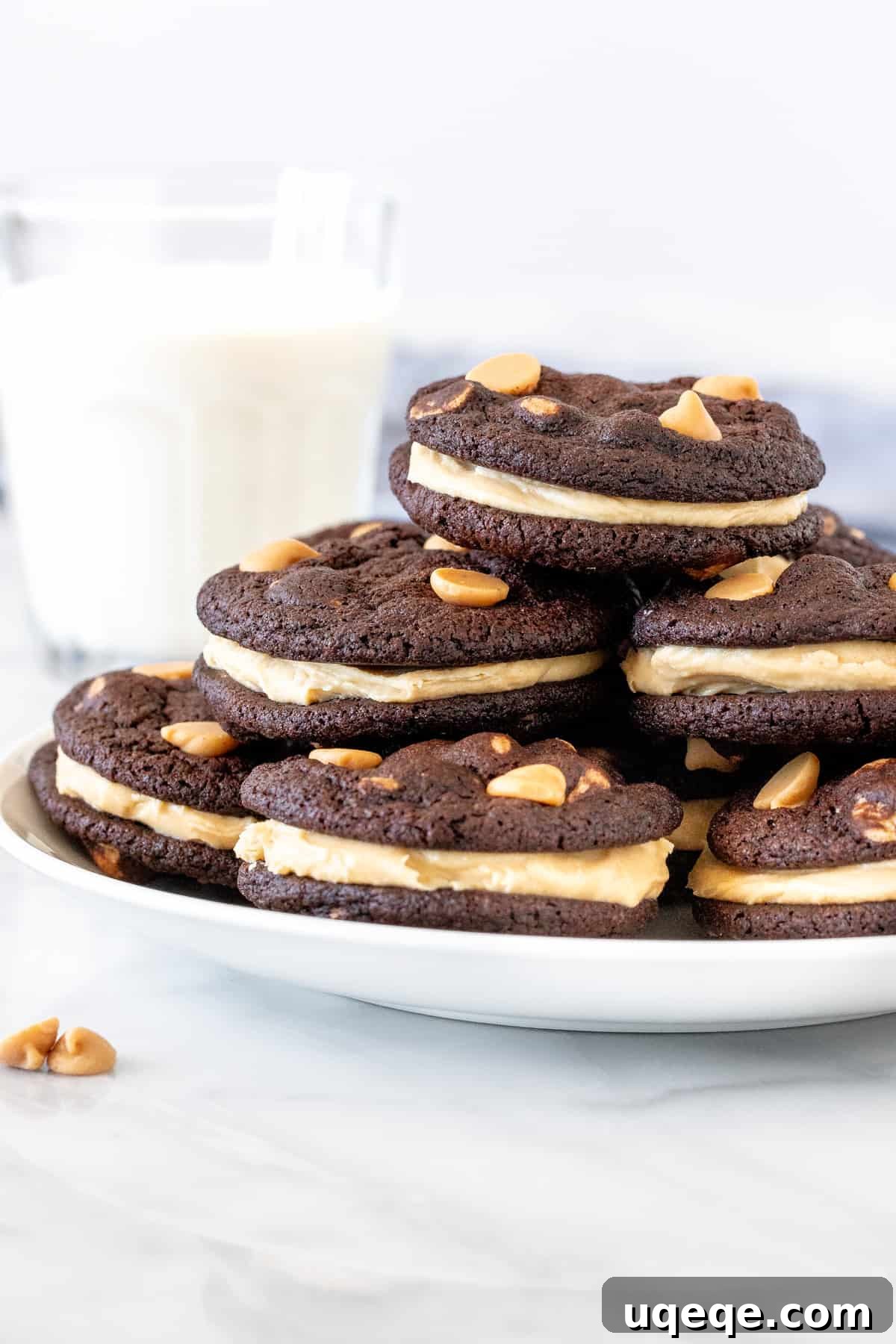 Decadent Chocolate Peanut Butter Stacks 2 Plate of chocolate peanut butter sandwich cookies, showcasing the fudgy chocolate cookie and creamy peanut butter frosting