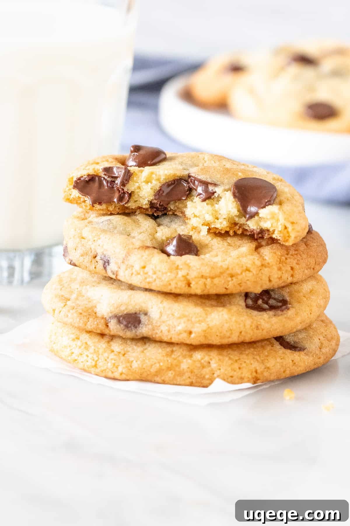 Perfect Chocolate Chip Cookies Brown Sugar Free 5 Stack of chewy chocolate chip cookies, with the top cookie broken in half, revealing a soft interior.