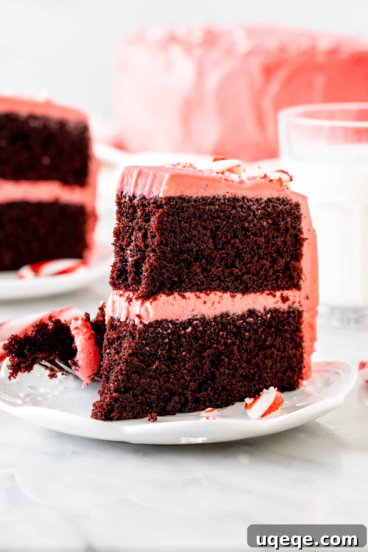 Peppermint Twist Chocolate Cake 5 A close-up of a slice of chocolate peppermint cake with a bite taken out, emphasizing its moist texture and delicious layers, a truly irresistible Christmas dessert.