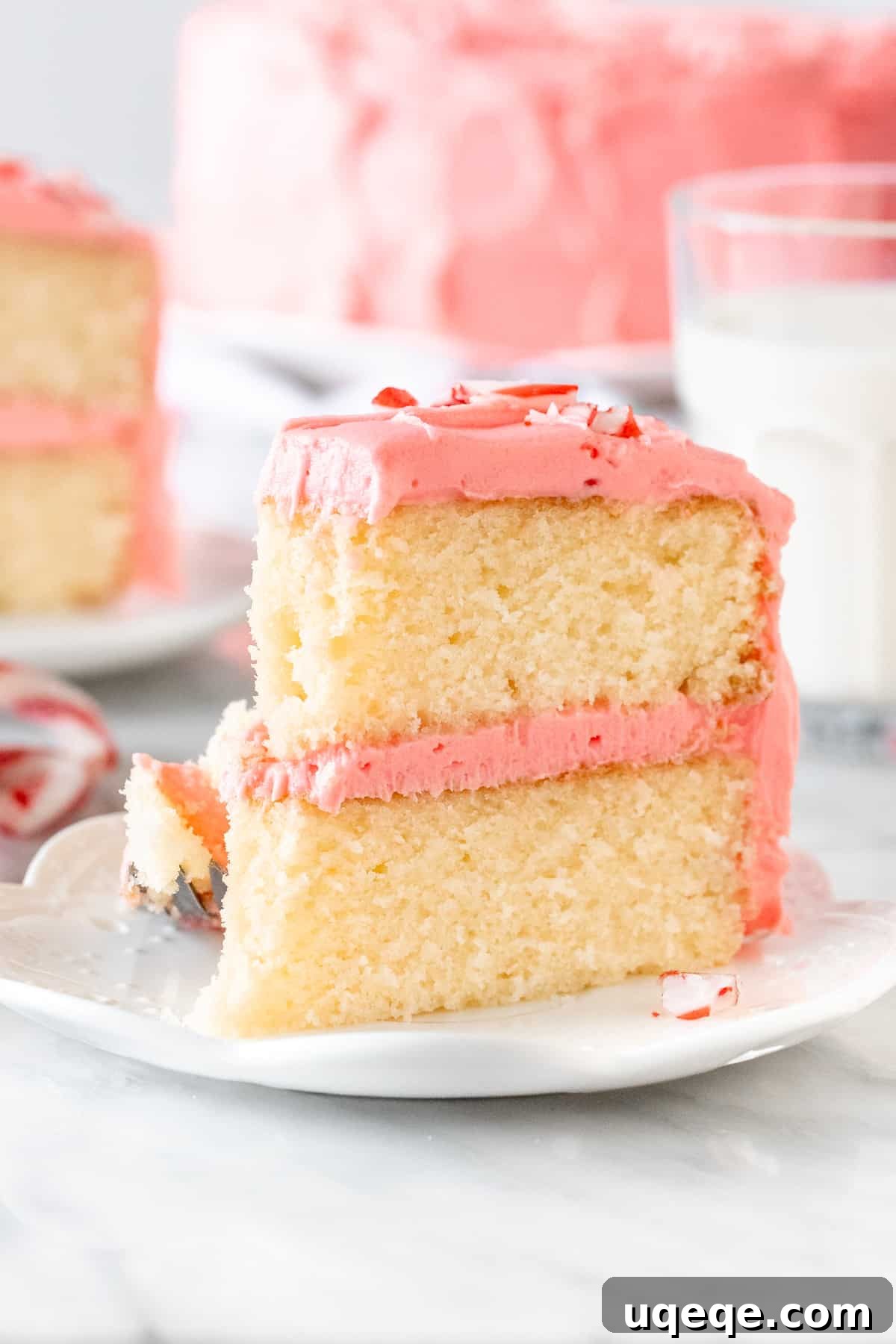 White Chocolate Peppermint Candy Cane Cake 4 Piece of peppermint layer cake with a bite taken out