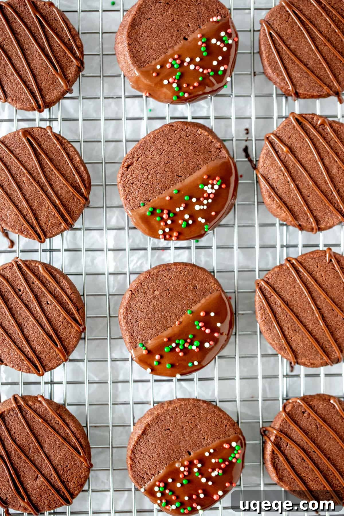 Buttery Chocolate Shortbread Bliss 4 Freshly baked chocolate cookies cooling on a rack, some decorated with chocolate drizzle and sprinkles