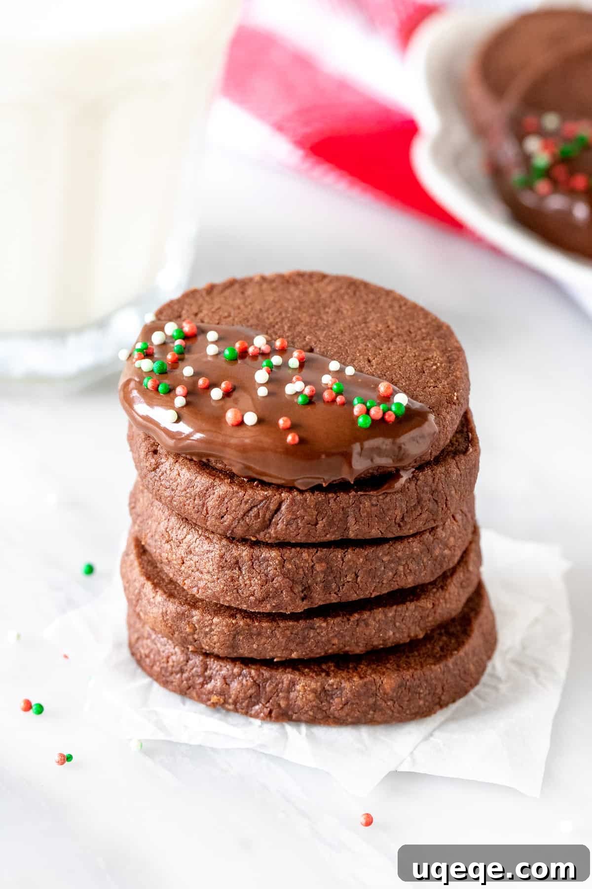 Buttery Chocolate Shortbread Bliss 5 Festive stack of chocolate shortbread cookies beside a glass of milk, ready for holiday enjoyment