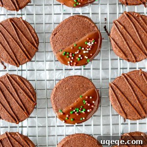 Chocolate shortbread cookies with chocolate drizzle on a cooling rack