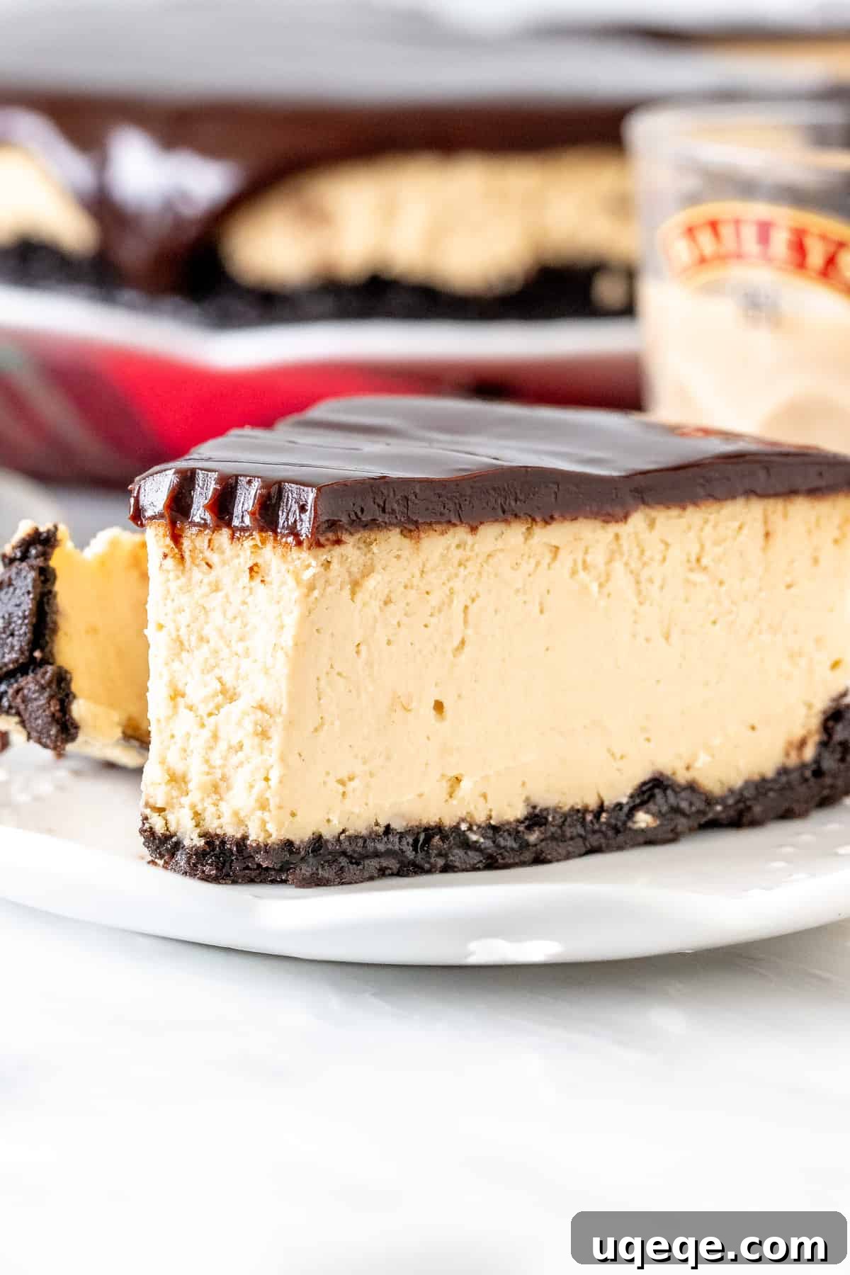 The Ultimate Baileys Irish Cream Cheesecake 4 Slice of Baileys cheesecake with Oreo crust and chocolate ganache