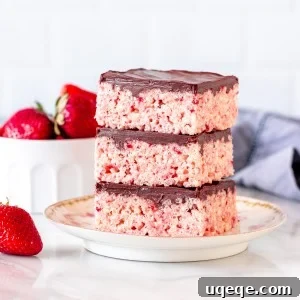 3 strawberry Rice Krispie treats with chocolate topping, stacked on top of each other