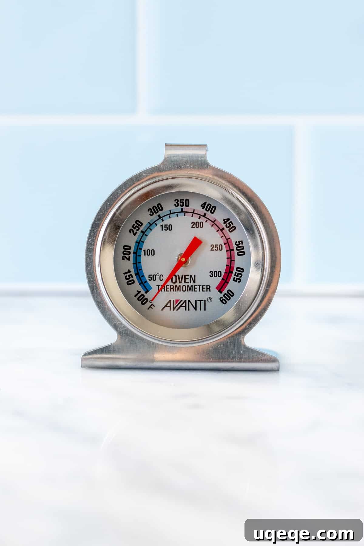 Unlock Your Baking Potential: Simple Tips for Superior Bakes 6 An essential oven thermometer placed prominently on a clean kitchen counter, highlighting its readiness to ensure accurate oven temperatures for baking success.