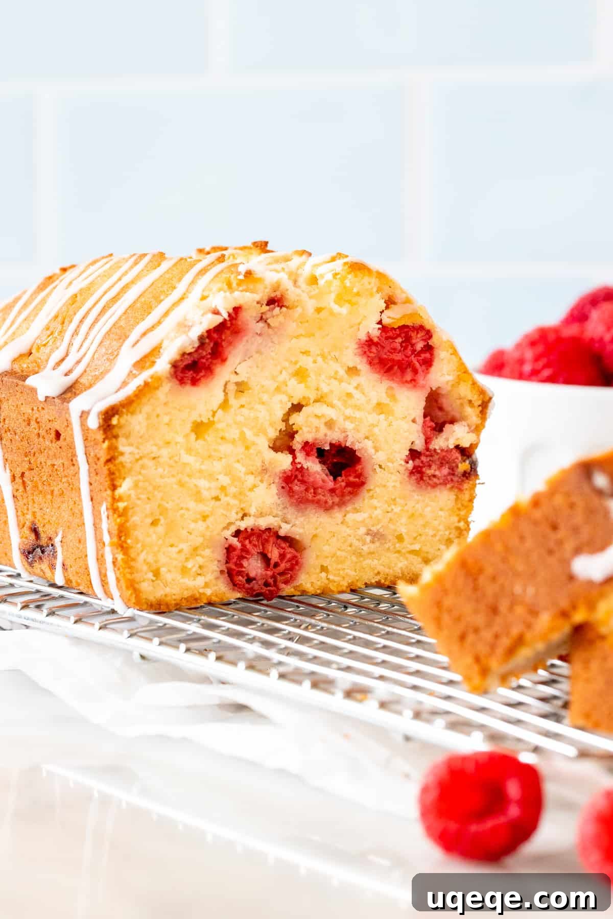 Tender Raspberry Bread Bursting with Juicy Berries 5 Half of a loaf of raspberry muffin bread, showing the appealing golden crust and berry-filled interior