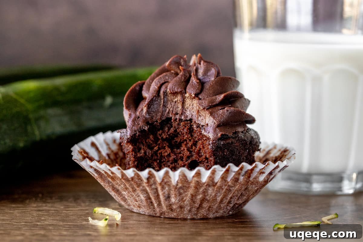 Decadent Chocolate Zucchini Cupcakes 6 Chocolate cupcake with a bite taken out with glass of milk