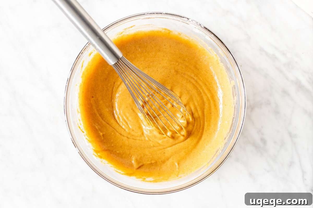 Layered Pumpkin Pie Fudgy Brownies 5 A bowl filled with smooth, spiced pumpkin batter, ready to be layered.