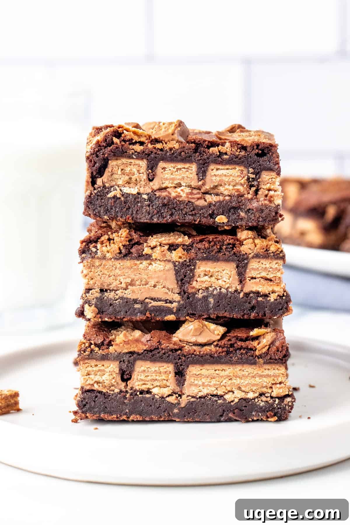 Ultimate Kit Kat Brownie Bars 2 A stack of three decadent Kit Kat brownies, showing their thick, fudgy texture and embedded Kit Kats.