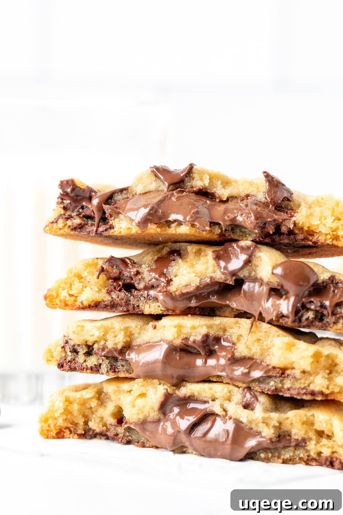 Nutella Lava Cookies 2 Stack of freshly baked Nutella stuffed cookies, one broken in half to reveal the gooey chocolate hazelnut center.