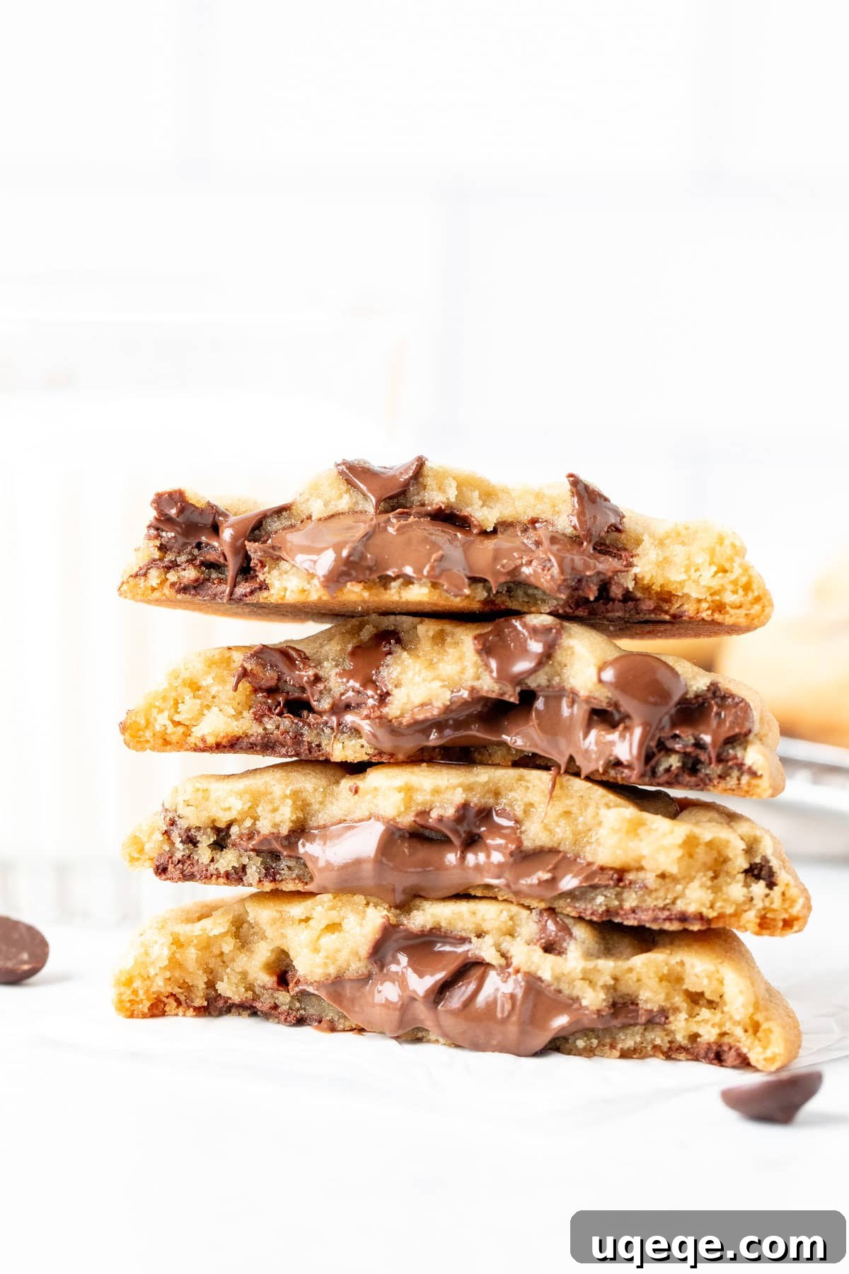 Nutella Lava Cookies 8 A tantalizing stack of Nutella chocolate chip cookies, broken in half to showcase their molten centers, ready to be devoured.