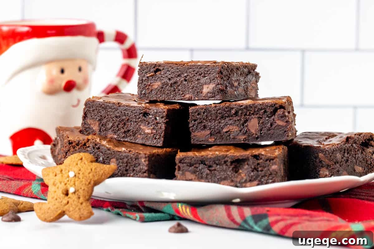 A close-up shot of a plate filled with several perfectly baked ginger molasses brownies, showing their rich color and inviting texture.