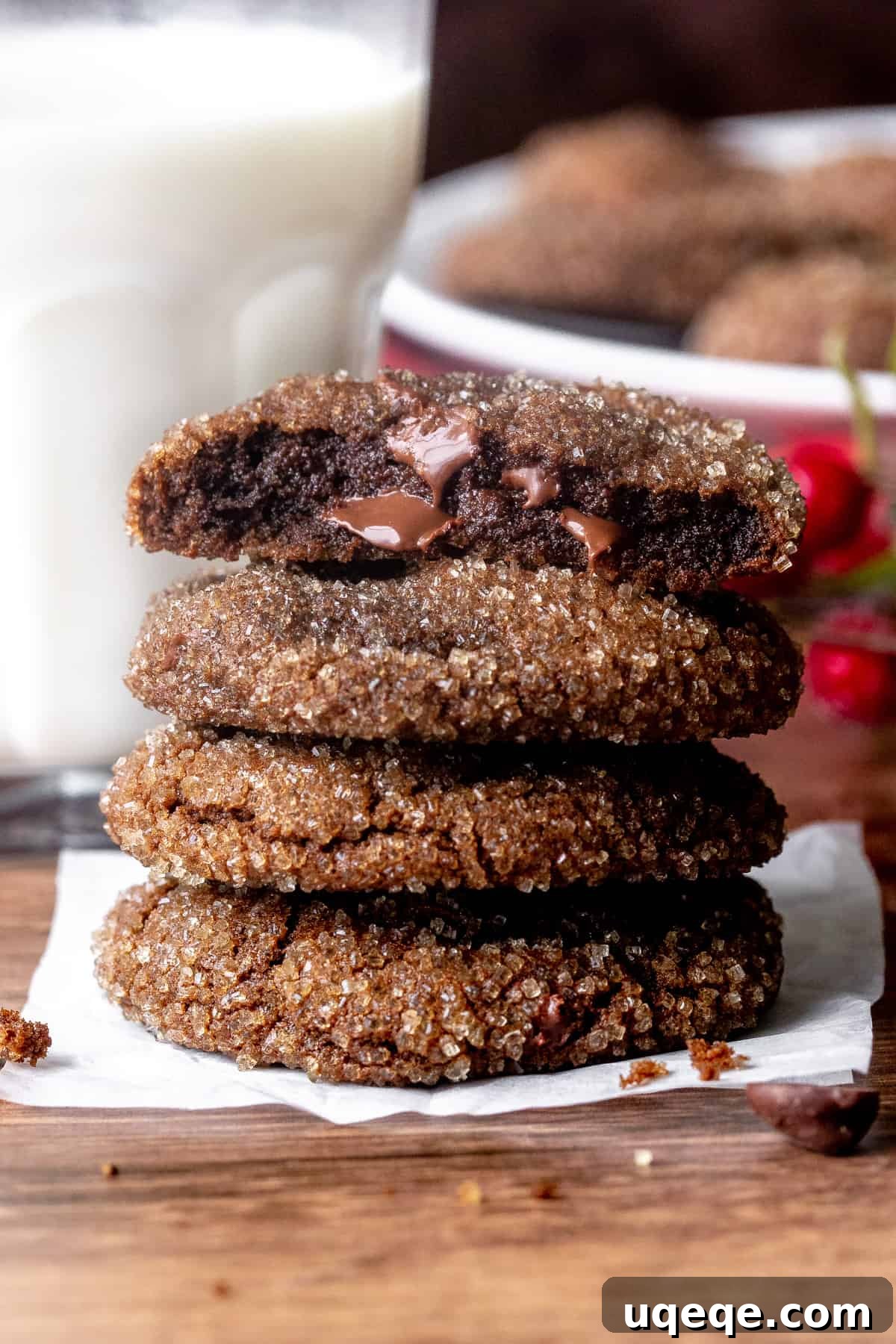 Stack of rich chocolate gingerbread cookies, with one cookie broken in half to reveal its soft, chewy interior. Perfect for holiday gifting and festive celebrations.