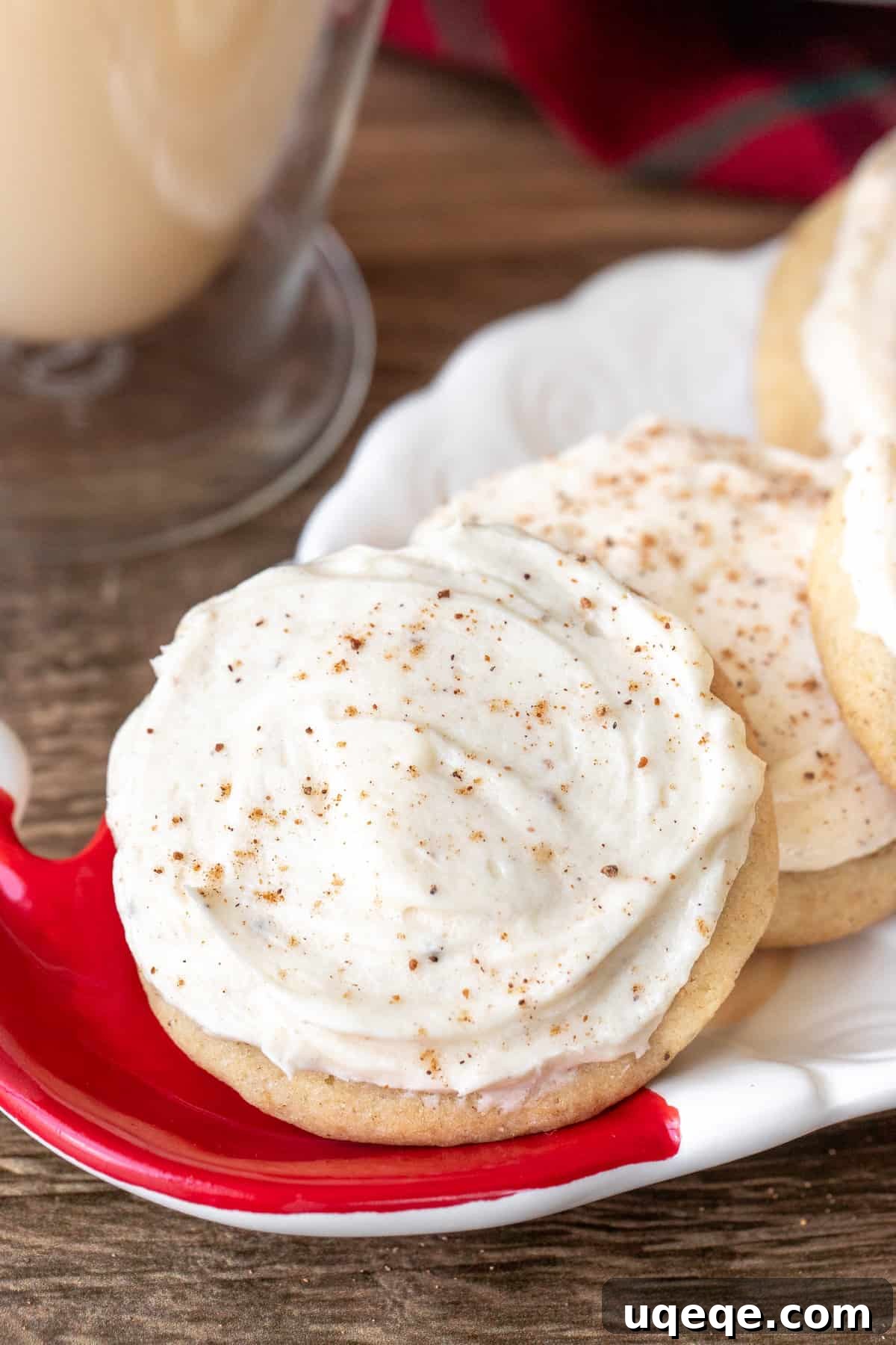 Spiced Eggnog Cookies with Creamy Frosting 2 Plate of soft and tender eggnog cookies with creamy eggnog frosting and a sprinkle of nutmeg, ready for holiday festivities.