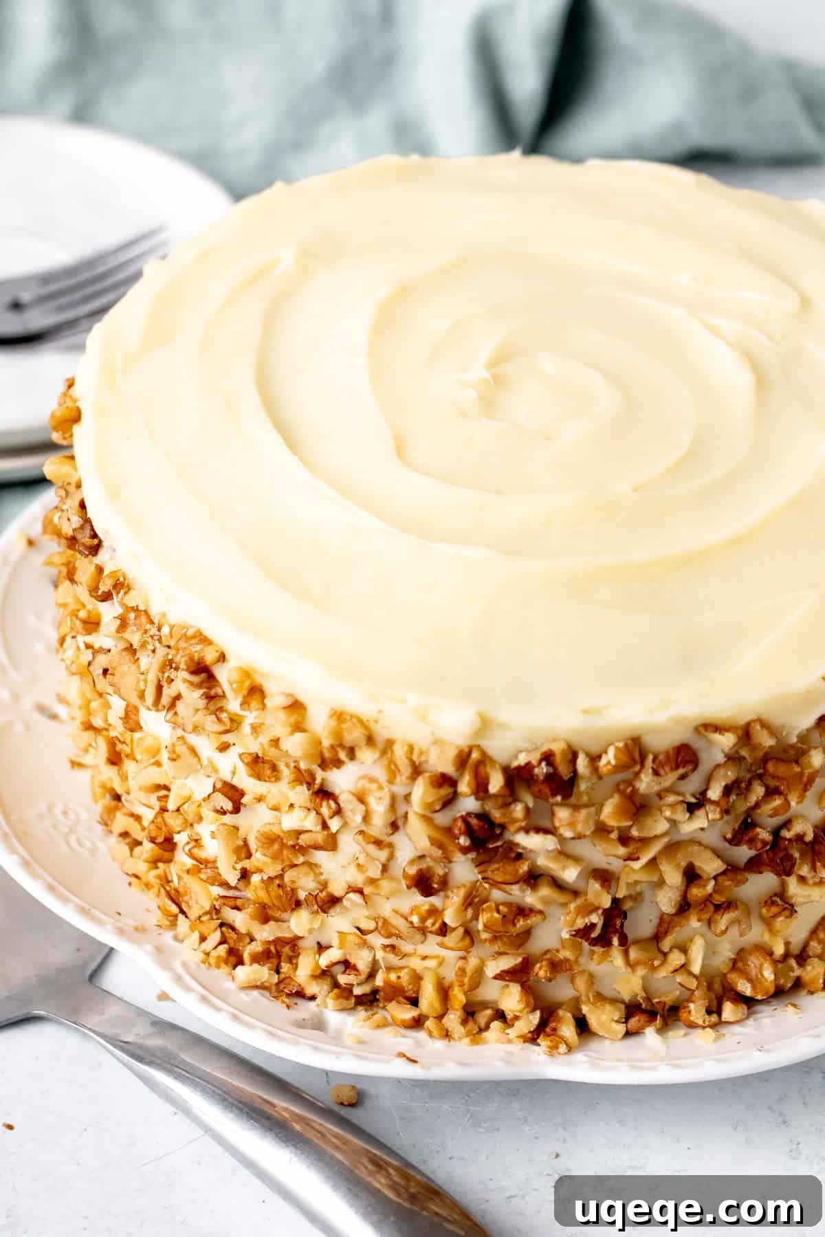 Classic Layered Carrot Cake with Cream Cheese Frosting 3 Close-up of a three-layer carrot cake showing its moist texture and rich cream cheese frosting between layers.