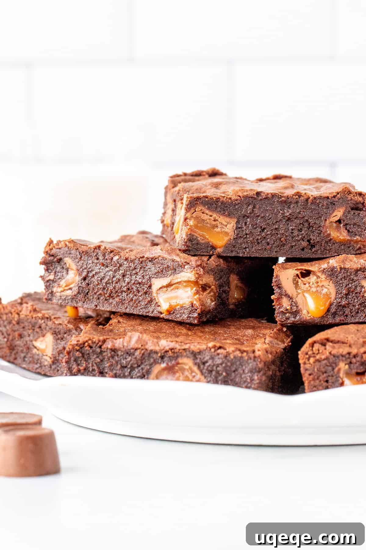 Gooey Rolo Stuffed Brownies 3 Plate of rich chocolate brownies stuffed with luscious Rolo candies, showing melted caramel