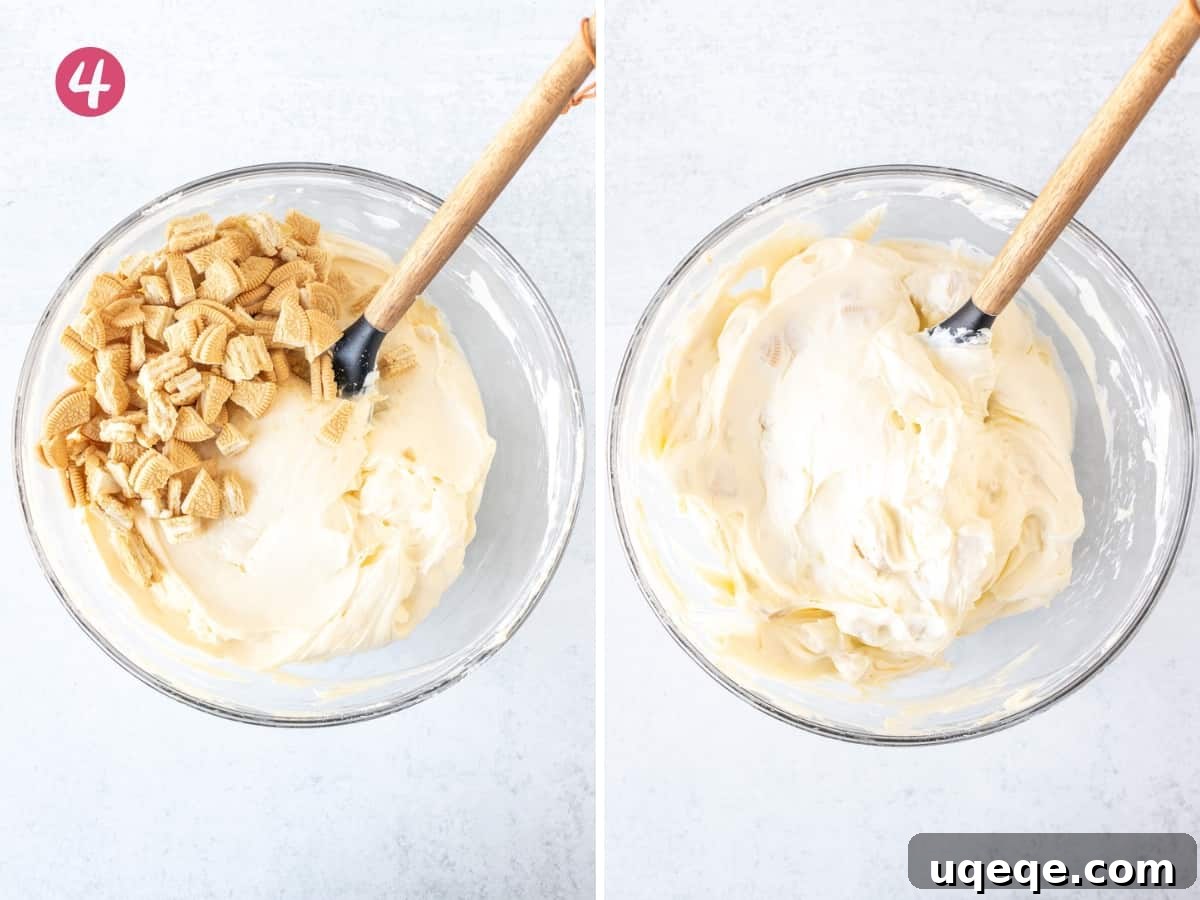 Ultimate Golden Oreo Cheesecake 7 A bowl of smooth no-bake cheesecake filling being mixed with chopped Golden Oreos, resulting in a perfectly incorporated, cookie-filled cheesecake batter.