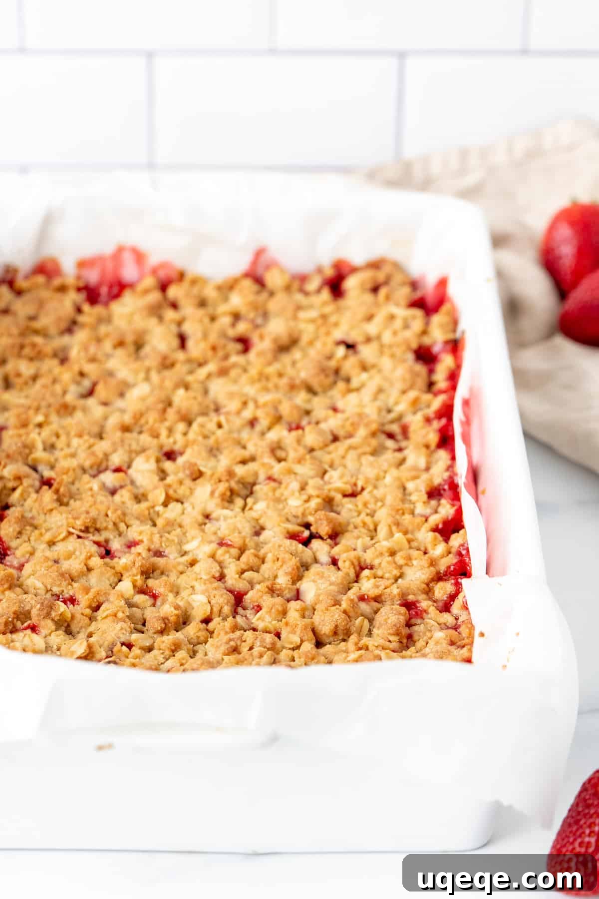 Sweet-Tart Strawberry Rhubarb Squares 5 Pan of strawberry rhubarb crumble bars freshly out of the oven, golden brown and bubbling.