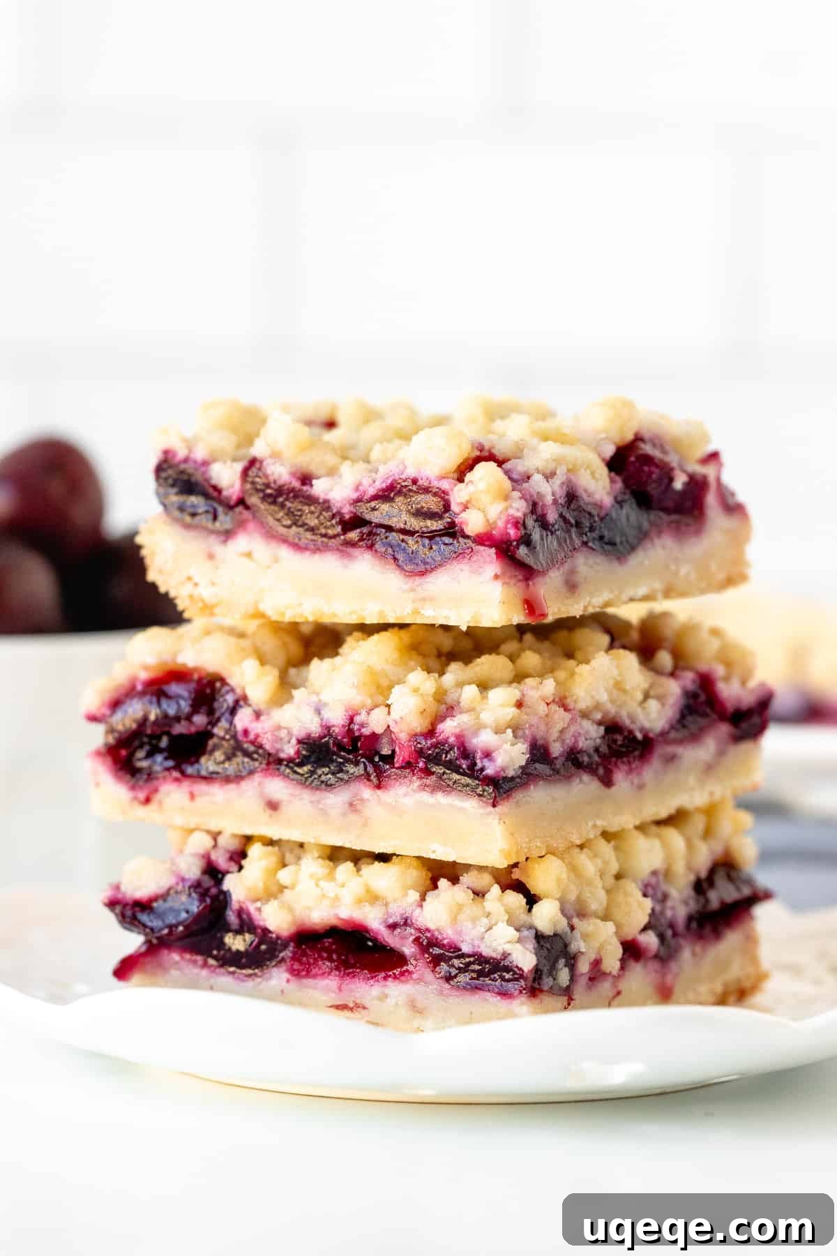 Irresistible Cherry Crumble Bars 2 Stack of three cherry crumb bars with a buttery shortbread base, sweet cherry middle, and crumb topping