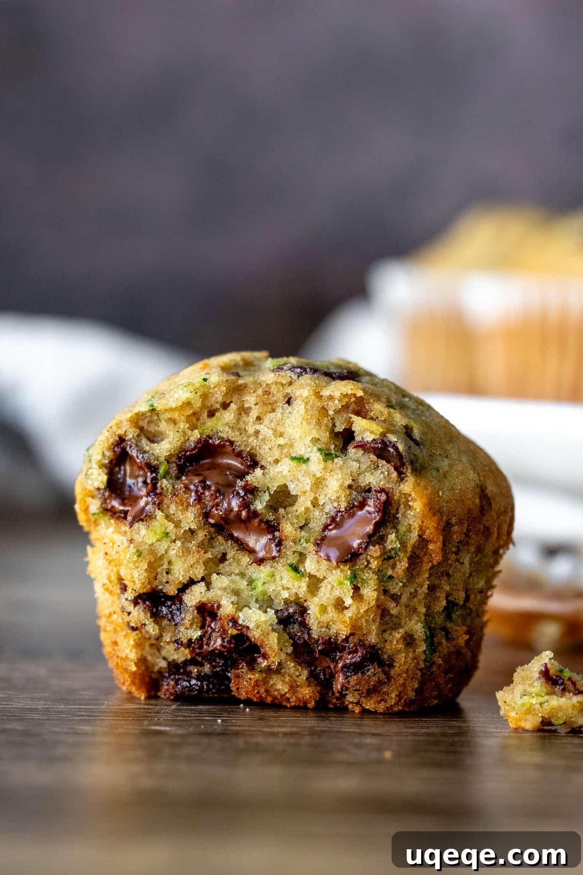Secret Zucchini Chocolate Chip Muffins 2 A half-eaten zucchini chocolate chip muffin showing its moist interior and melted chocolate chips