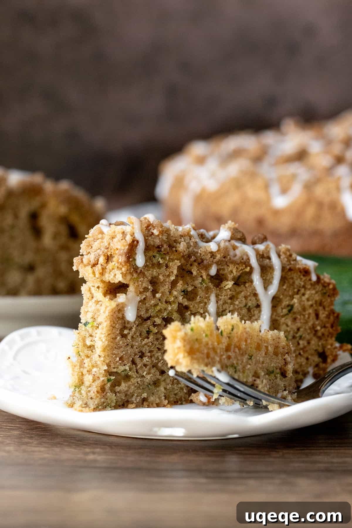 Cinnamon Swirl Zucchini Coffee Cake 9 Close-up of a slice of zucchini coffee cake, showing the moist interior, the streusel topping, and a hint of glaze.
