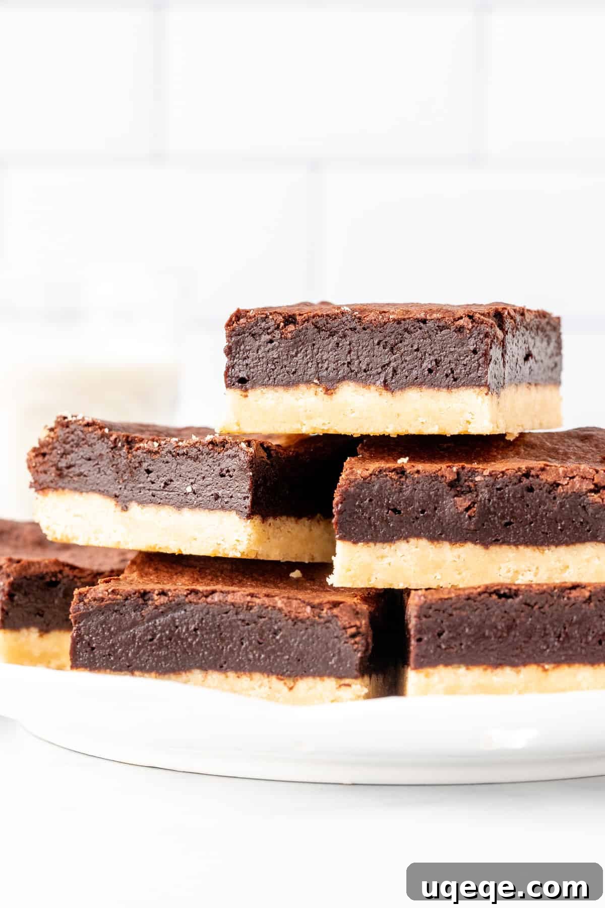 Buttery Brownie Bliss 3 Plate of shortbread brownies, stacked neatly on top of each other, ready to be enjoyed