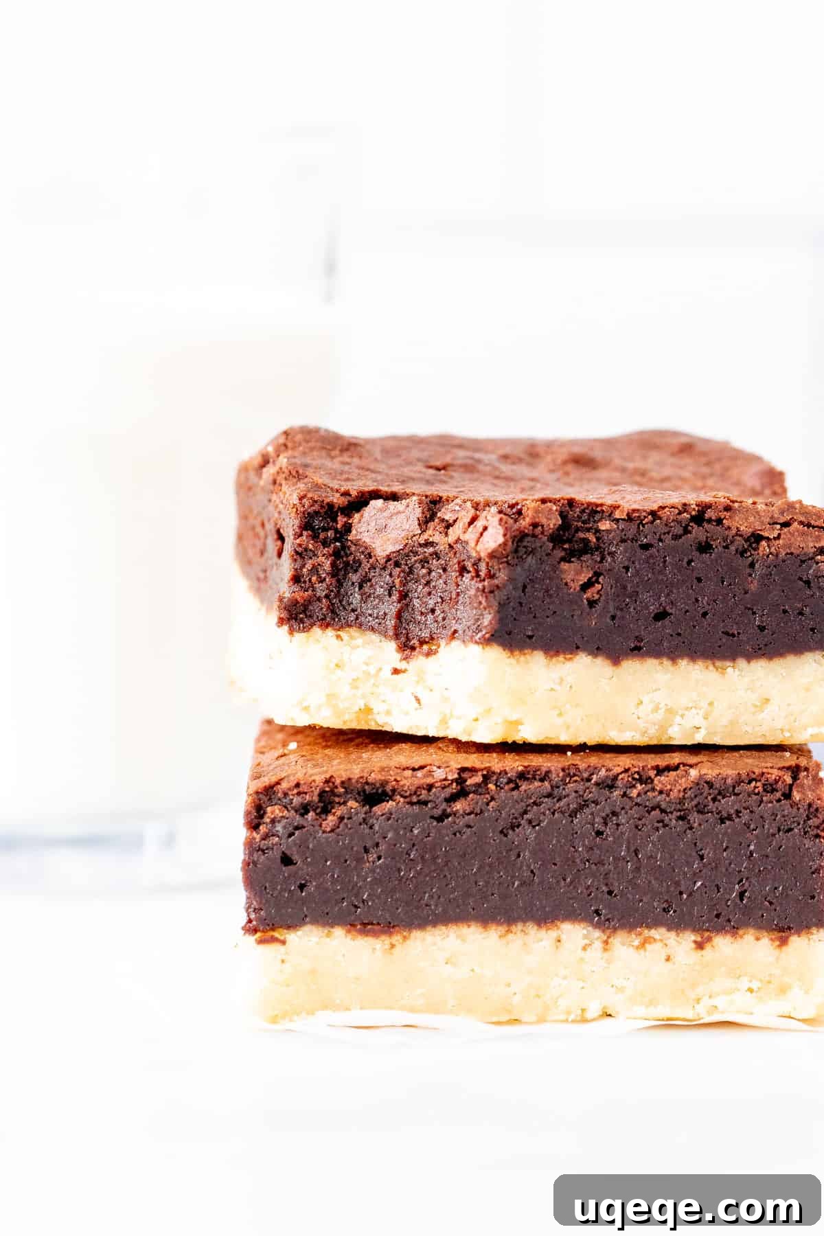Buttery Brownie Bliss 7 Two perfectly sliced Shortbread Brownies, stacked, highlighting the distinct layers of buttery shortbread and rich fudgy brownie