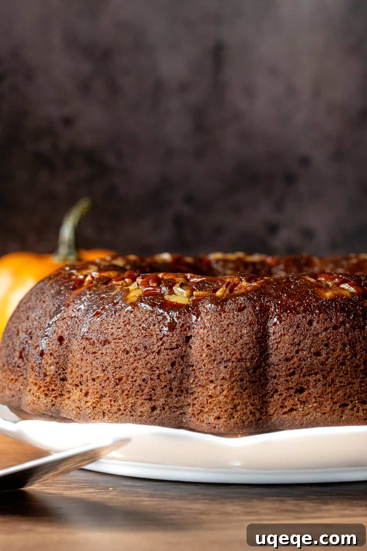 Warm pumpkin rum cake with toasted pecans, brushed generously with butter rum sauce.