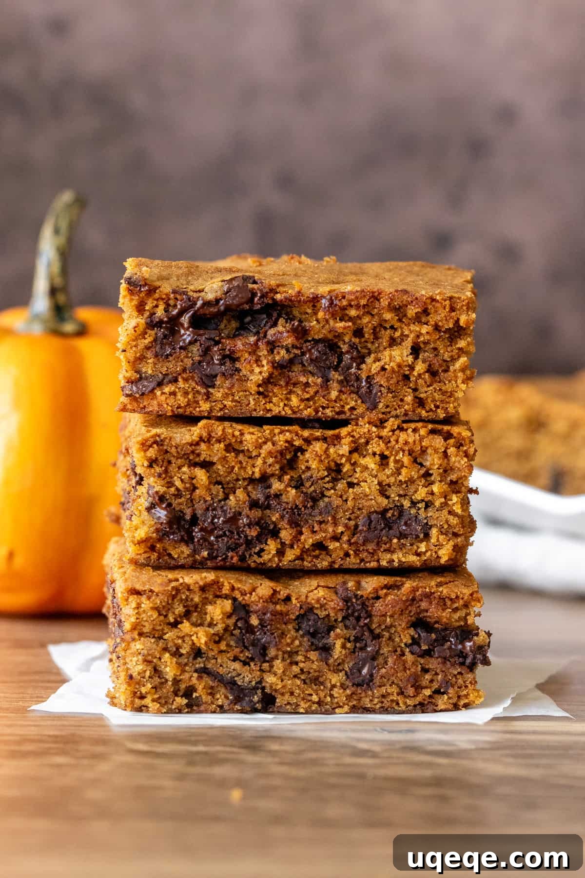 Harvest Pumpkin Chocolate Chip Delights 4 Three perfectly baked pumpkin cookie bars, stacked to show their moist interior and chocolate chips.