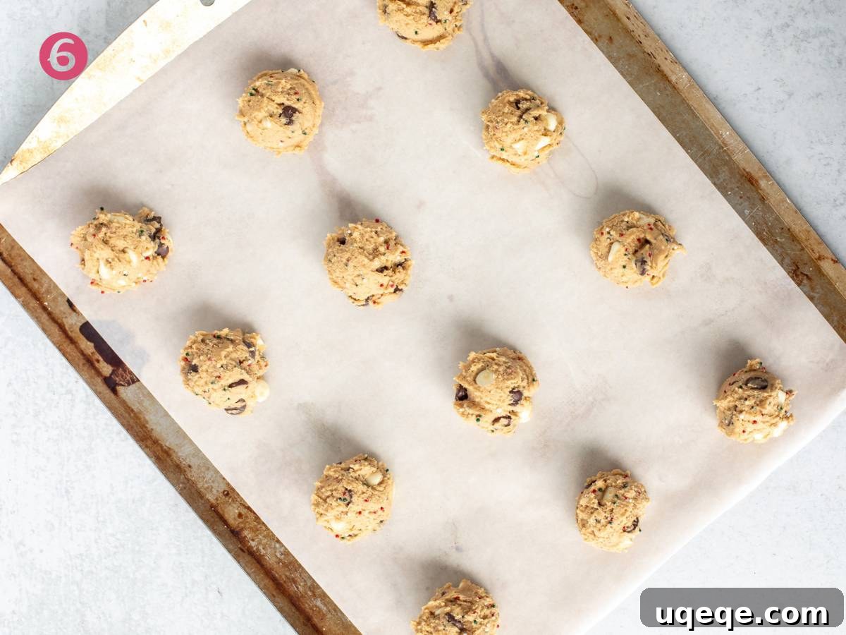 A baking tray filled with perfectly portioned cookie dough balls, ready to be baked into delicious Christmas cookies.