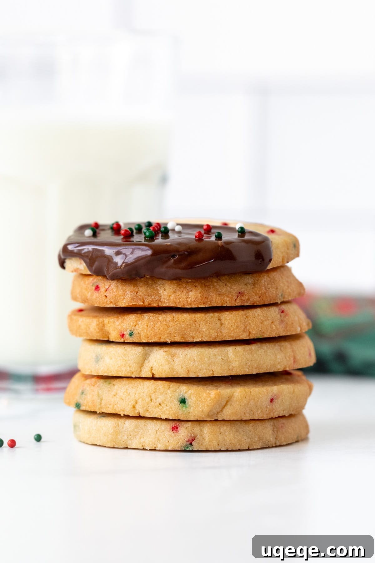 Holiday Sparkle Slice and Bake Cookies 5 Stack of Christmas sprinkle slice and bake cookies, top cookie dipped in chocolate and decorated with sprinkles