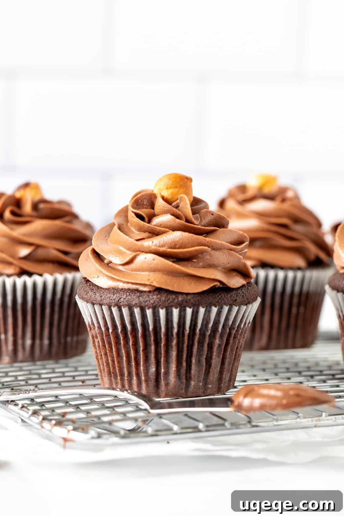 Decadent Nutella Frosting 4 Chocolate cupcakes piped with creamy Nutella buttercream frosting, ready to serve